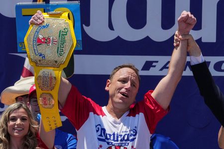 Joey Chestnut Claims 18th Hot Dog Title, But Brutal Heat Cuts His Count Short